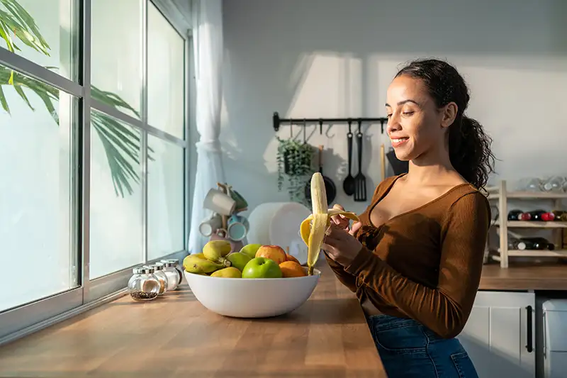 A young lady eating a high-fiber diet to help with a bladder issue.