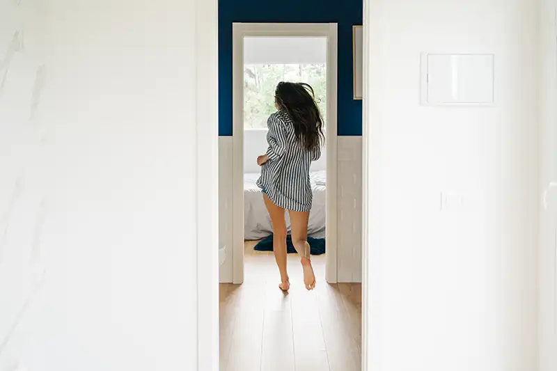 A woman running to the restroom due to urinary frequency.